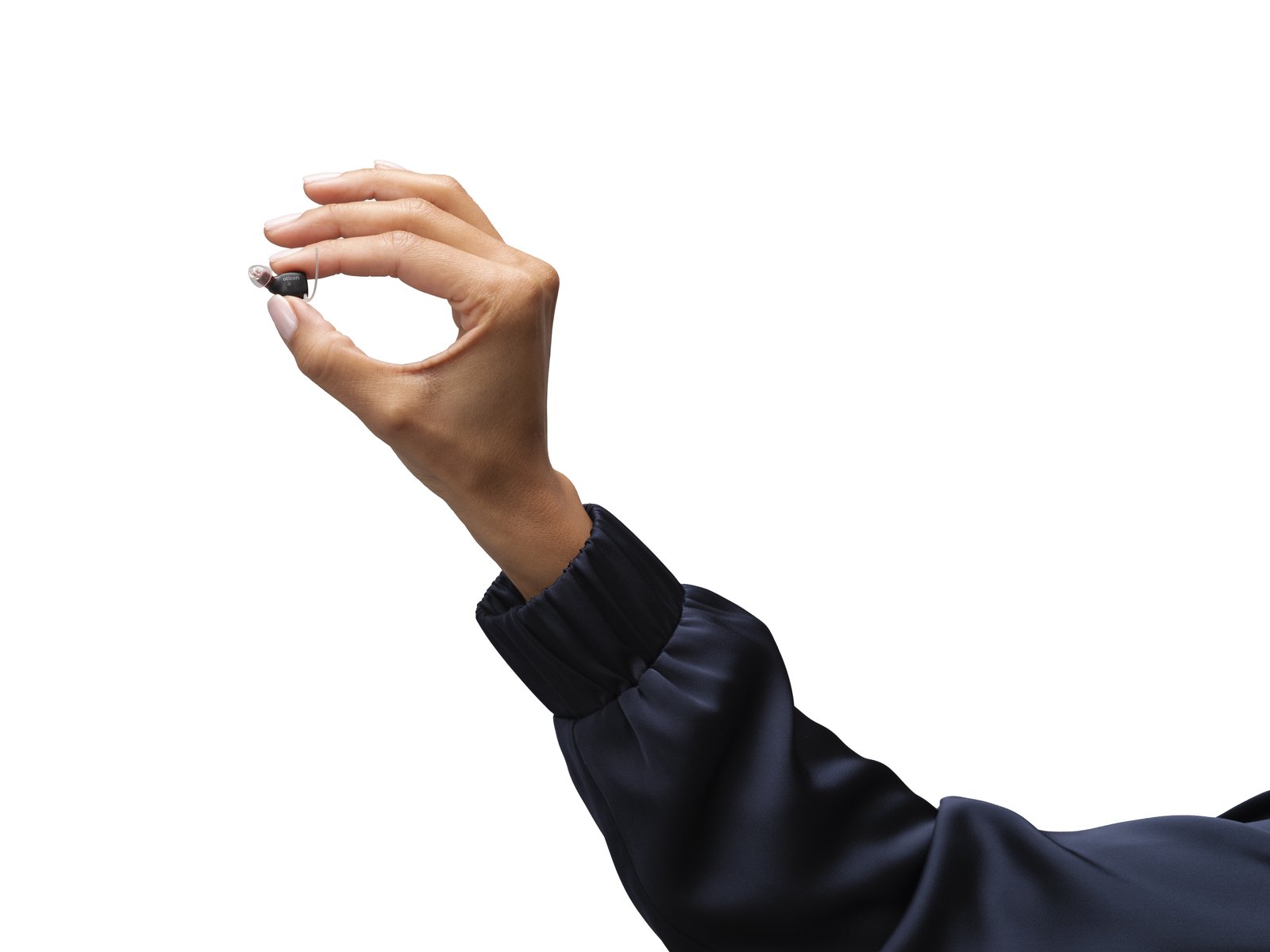 Oticon Zeal NXT hearing aid held in hand — shows the small size of the device