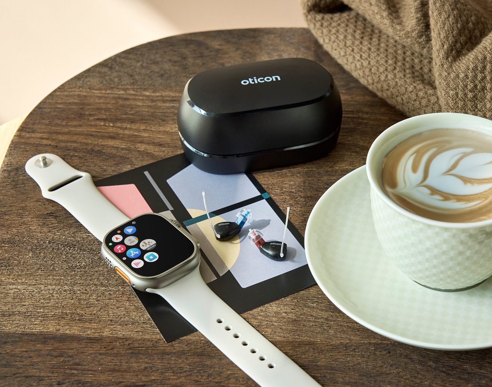 Oticon Zeal NXT with Apple Watch and coffee cup — premium discreet hearing aid for active lifestyle