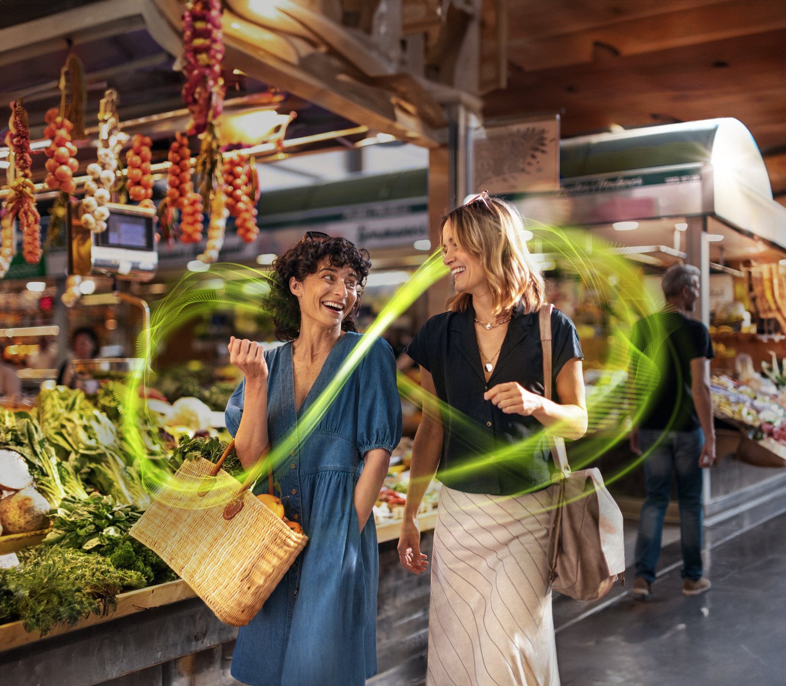 Two people having a clear conversation in a noisy outdoor restaurant setting — the kind of situation the Audéo Sphere Infinio is designed for